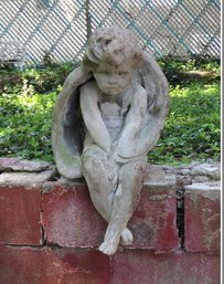 A Seated Concrete Cherub Angel Statue