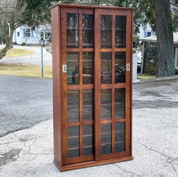 An Oak Cabinet With Sliding Glass Doors