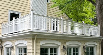 A Beautiful Painted Wood Porch Railing With Copper Post Caps