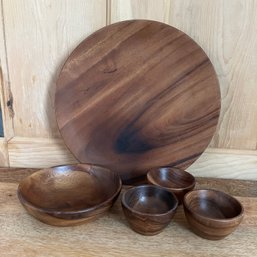 A Set Of Carved Wooden Plates And Bowls