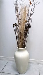 A Large Ceramic Vase With Reeds And Grass Decor
