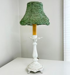 A Cast Iron Stick Lamp With Beaded Shade