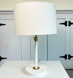 A Table Lamp With Brass Accents