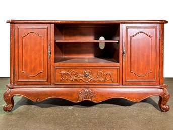 A Vintage Carved Wood Entertainment Console In Country French Style