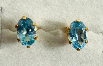 14K GOLD FACETED OVAL BLUE TOPAZ STUD EARRINGS