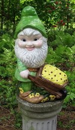 An 18' Ceramic Garden Gnome With Wheel Barrel