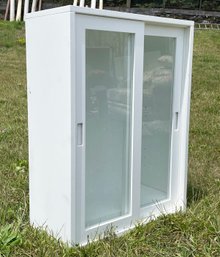 A Solid Wood Cabinet With Glass Sliding Doors And Adjustable Shelves (1 Of 2)