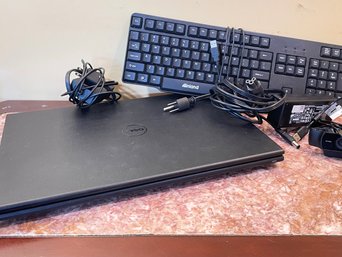 A Dell Laptop And Keyboard