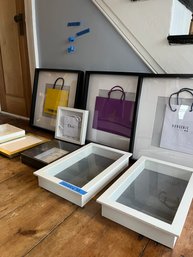 An Assortment Of Frames And Framed Couture Shopping Bags