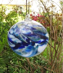 A Colorful Blown Glass Cobalt And Milk Infused Hanging Globe