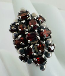 PRETTY STERLING SILVER FACETED OVAL AND ROUND RUBY RING