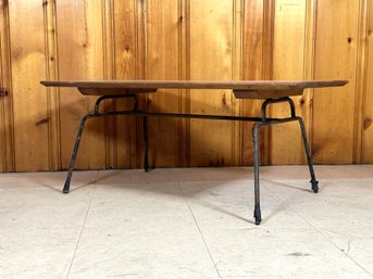 A Vintage Coffee Table With A Wrought Metal Base & Simple Wood Top