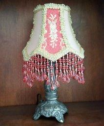 A Bronze And Beaded Accent Lamp