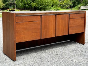 A Mid Century Modern Credenza Of Teak With Formica Top And Chrome Trim