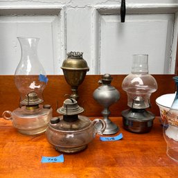 A Variety Of Antique Oil Lamps And Two Extra Shades