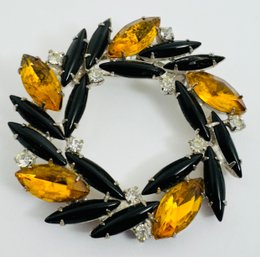 VINTAGE SILVER TONE YELLOW, BLACK AND WHITE RHINESTONE PINWHEEL FORM BROOCH