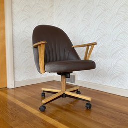 A Rolling Desk Chair With Wood Trim