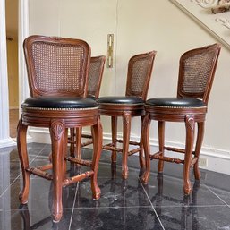 A Set Of 4 Elaborate Wood Swivel Stools With Cane-Back Leather Seats