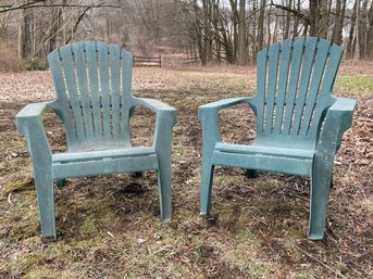 A Pair Of Resin Adirondack Chairs