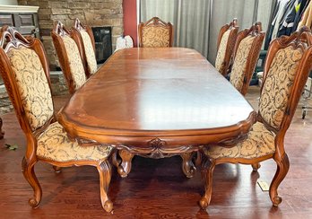 An Ornately Carved And Inlaid Wood Dining Table And Set Of 8 Chairs