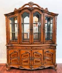 A French Provincial China Cabinet With Beveled Glass Doors