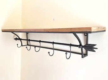 A Metal And Wood Wall Shelf And Hook Unit