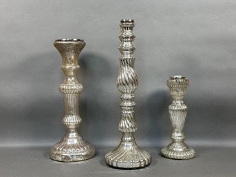 A Set Of Three Mercury Glass Candlesticks