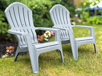 A Pair Of Moulded Plastic Outdoor Adirondack Chairs