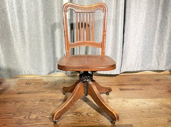 An Antique Carved Oak Spindle Back Adjustable Height Desk Chair