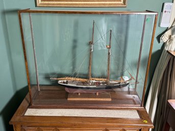 AN ANTIQUE CASED SAILBOAT