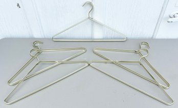 A Set Of 5 Vintage Brass Coat Hangers