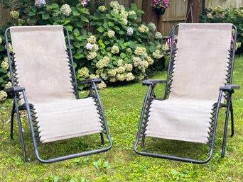 A Pair Of Metal And Mesh Folding Lounge Chairs