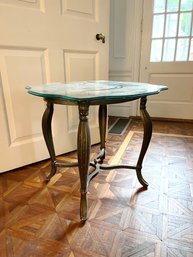 A Metal Base End Table With Glass Top