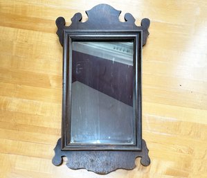 An Antique Scrolled Mahogany Mirror