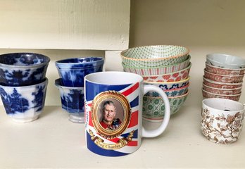 An Assortment Of Mugs And Colorful Dessert Bowls And More