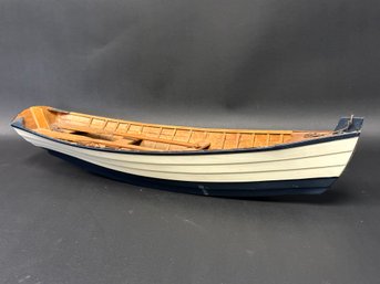 A Vintage Model Rowboat In Wood