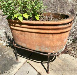 A Vintage Terra Cotta Planter On Wrought Iron Stand