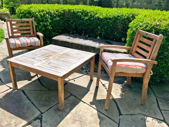 A Weathered Teak Coffee Table And Pair Of Arm Chairs By ALK Brands With Tommy Bahama Cushions
