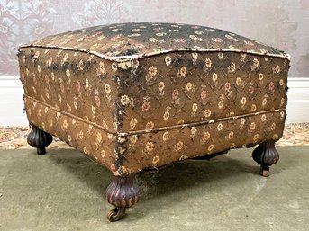 An Antique Bun Foot Ottoman