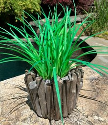 A Faux Grass In Driftwood Planter