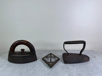 Pair Of Antique Irons With Monogrammed 'T' Trivet