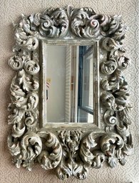 A Large, Ornately Cast Mirror, Faux Finished