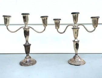 A Pair Of Weighted Sterling Candlesticks By Crown