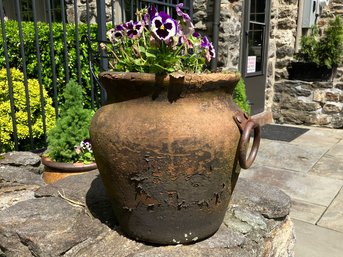 A Terra Cotta Planter With Live Flowers