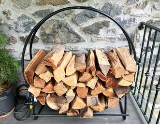 A Modern Tubular Steel Wood Holder With Firewood