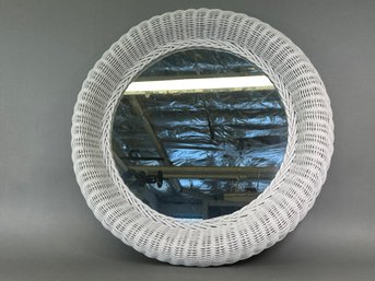A Round White Wicker Mirror