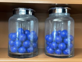 A Pair Of Large Glass Canisters With Golf Balls