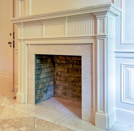 A Fireplace With Honed Granite Mantle Shelf