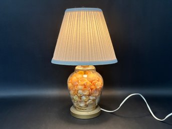 A Vintage Glass Urn Lamp Filled With Natural Seashells