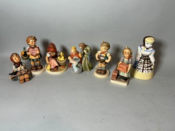 SIX HUMMEL FIGURINES AND A CALIFORNIA FIGURINE